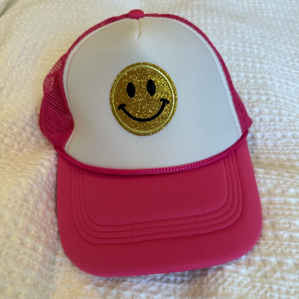 Pink smiley face trucker hat